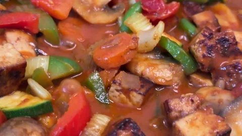 Sizzling tofu and vegetable stir-fry: a close-up of healthy vegan cuisine. Stock Footage 310194185