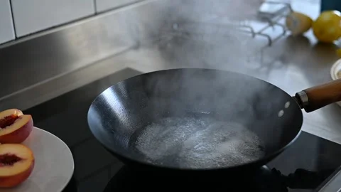 Sizzling Wok: Masterful Dumpling Preparation on Cooktop 動画素材 243363968