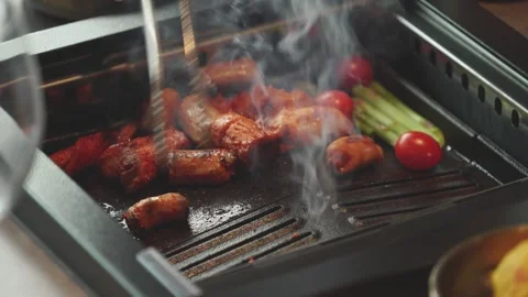 Sizzling Yang Daechang on Heated Pan Stock Footage 334697702