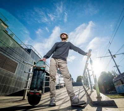 Skatboarder practicing and jumping on the streets. Stock Photos