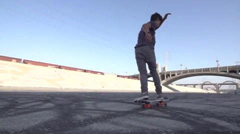 Skate Boarder Does Trick in Slow Motion Los Angeles River Grunge Stock Footage 56100796