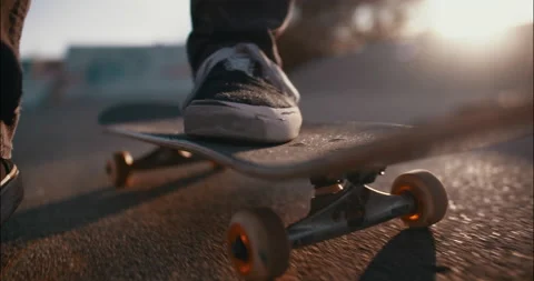 Skateboard detail while pushing through the skatepark sunflare backlight sun Stock-Footage 153500201