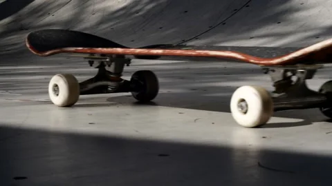 Skateboard rolling on flat bottom of a ramp Stock-Footage 136021226