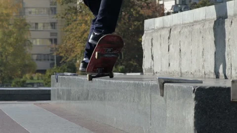 Skateboarder does grind trick 5-0 on street ledge, architectural monument Stock Footage 96722941