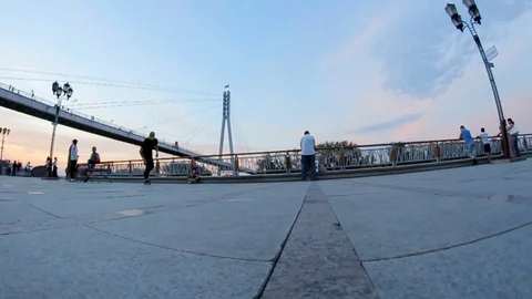 Skateboarder doing a difficult trick on a busy street Stock Footage 71820475