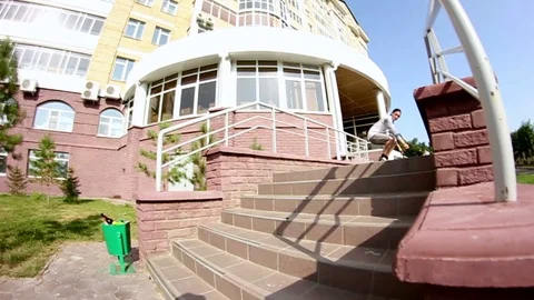 Skateboarder doing a flip trick over the stairs Stock Footage 69789749