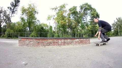 Skateboarder doing trick on grindbox in the skate park Stock Footage 69789350