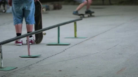Skateboarder falling on the ground after attempting a trick at a skatepark Stock Footage 336690787