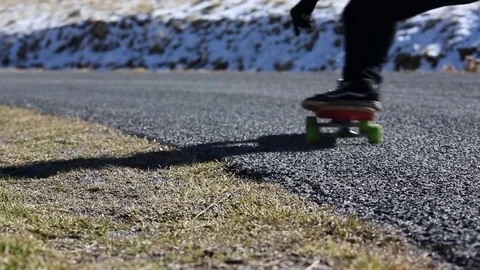 Skateboarder on a mountain road Stock Footage 84301663