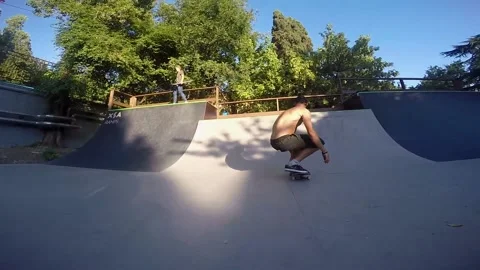 Skateboarder performs the jump and rolls down Video stock 93934070