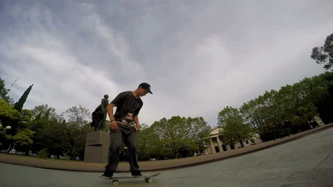Skateboarder performs tricks and in the end slides off from the skateboard Video stock 93928940