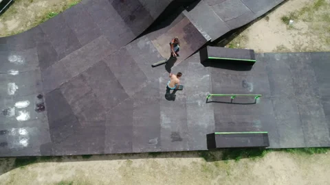 Skateboarder performs tricks in a skate park and slides off from skateboard Video stock 103032719