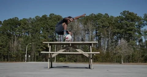 Skateboarder picnic table jump Video stock 52073899