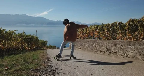 Skateboarder riding on empty road Stock Footage 105588791