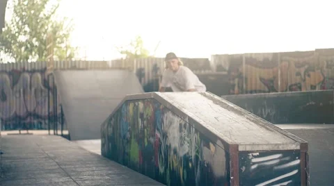 Skateboarder on skate doing jump tricks HD slow motion video on skateboard park Stock Footage