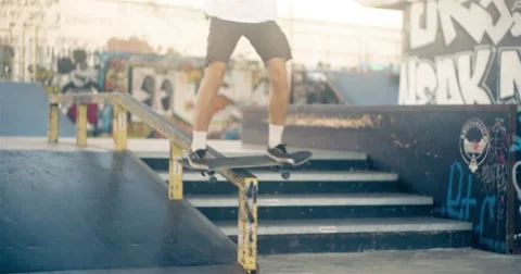 Skateboarder on skate doing rail slide grind tricks HD video on skateboard park Stock Footage 67861671