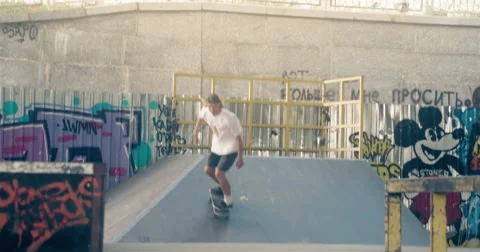 Skateboarder on skate doing rail slide grind tricks HD video on skateboard park Stock Footage 67861677