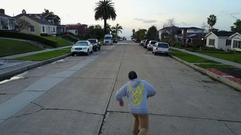 Skateboarder skating down street Stock Footage 71153080