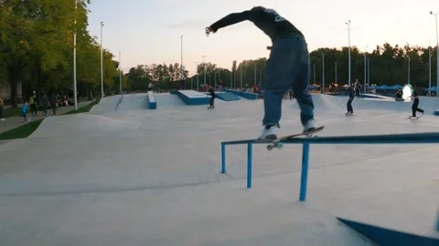 Skateboarder slides on the rail Stockbeeldmateriaal 256696172