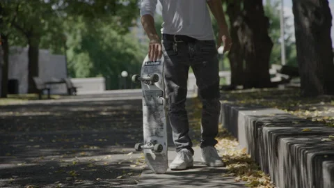 Skateboarder spinning his board getting ready to go Stock Footage 204875679