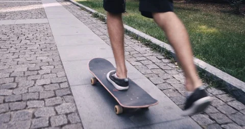 Skateboarder in a summer park 3k slowmotion Stock Footage
