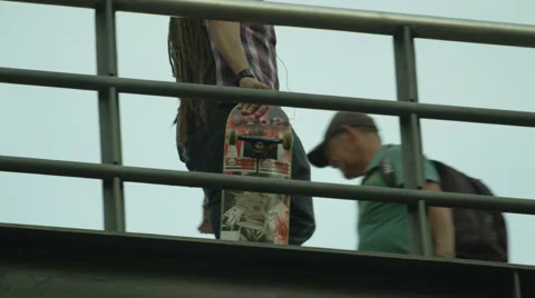 Skateboarder walking on the bridge Stock Footage 61274403