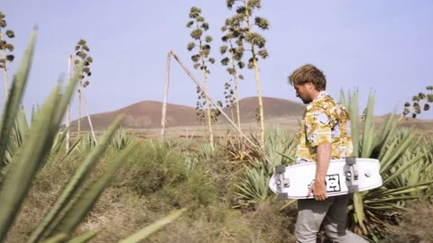 Skateboarder walking in the field Stock Footage 71829453