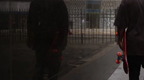 Skateboarder walking on the footpath Video stock 61273240