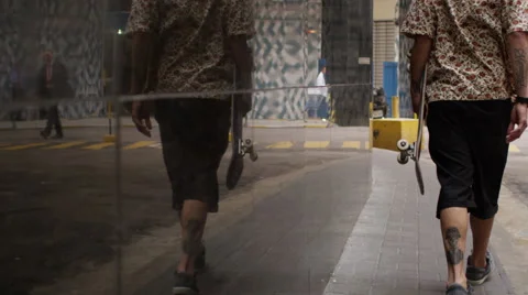 Skateboarder walking on the footpath Video stock 61273292