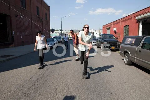 Skateboarders on urban street Stock Photos