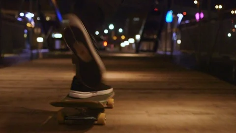 Skateboarding on bridge at night Stock Footage