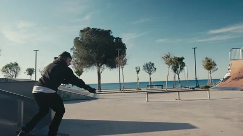 Skater boy practicing at skate park. Young man doing skateboard tricks at Stock Footage 194495265
