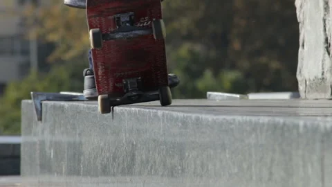 Skater does grind trick 5-0 on street ledge, architectural monument, close-up Stock Footage 96720963