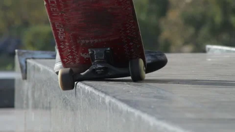 Skater does grind trick 5-0 on street ledge, architectural monument, close-up Stock Footage 96721464
