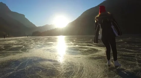 SKATER ON A FROZEN LAKE IN A FANTASTIC SUNSET 1080p Stock Footage
