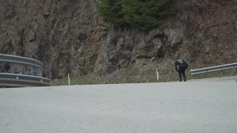 Skater Gains Speed Rolling Down Mountain Road Stock Footage 304578028