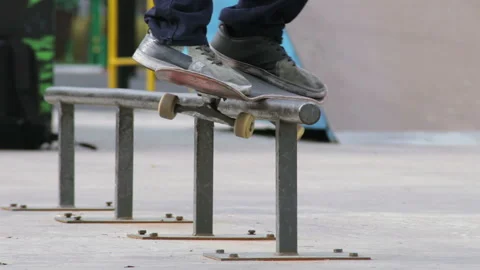 Skater make grind feeble 180 on rail in skatepark, close-up view in slowmotion Stock Footage 96197959