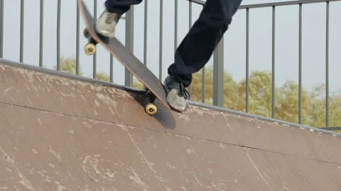 Skater make trick feeble stand on edge of ramp radius, close-up, slowmotion Stock Footage 96129833