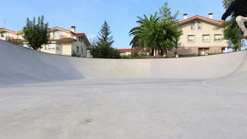 Skater Practicing Smooth Moves in the Bowl of a Skate park with Dynamic Energ Stock Footage 285765905