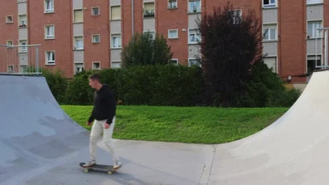 Skater Practicing Tricks on the Half-Pipe at Sunset in the Skate park Stock Footage 285765915