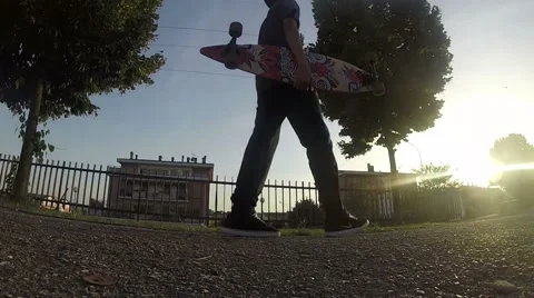 Skater walking at sunset [FULL HD] Stock Footage