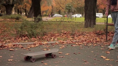 Skater while picking up skateboard continue walking slow motion Video stock 68354163