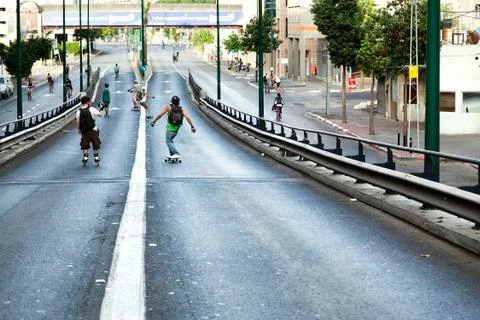 Skaters on a bridge Stock Photos