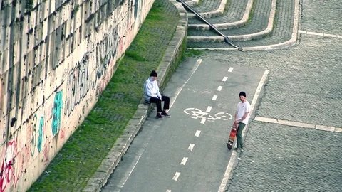 Skaters Doing Tricks Near Graffiti Wall Stock Footage 71967264