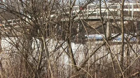 Skaters on ice under a bridge Stock Footage 10767669