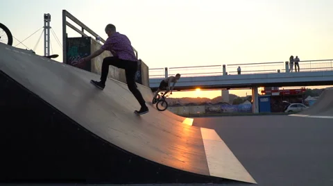 Skaters on the ramp before sunset Stock Footage 64683379