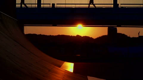 Skaters on the ramp before sunset Stock Footage 64683384