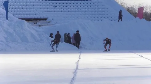 Skaters start on the competition at the stadium in the winter Stock Footage 124379478