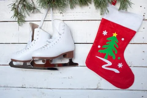 Skates and pine branches on a background of white wood Stock Photos