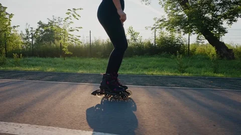 Skating along the path during sunset on a warm evening in the park Stock Footage 285151976